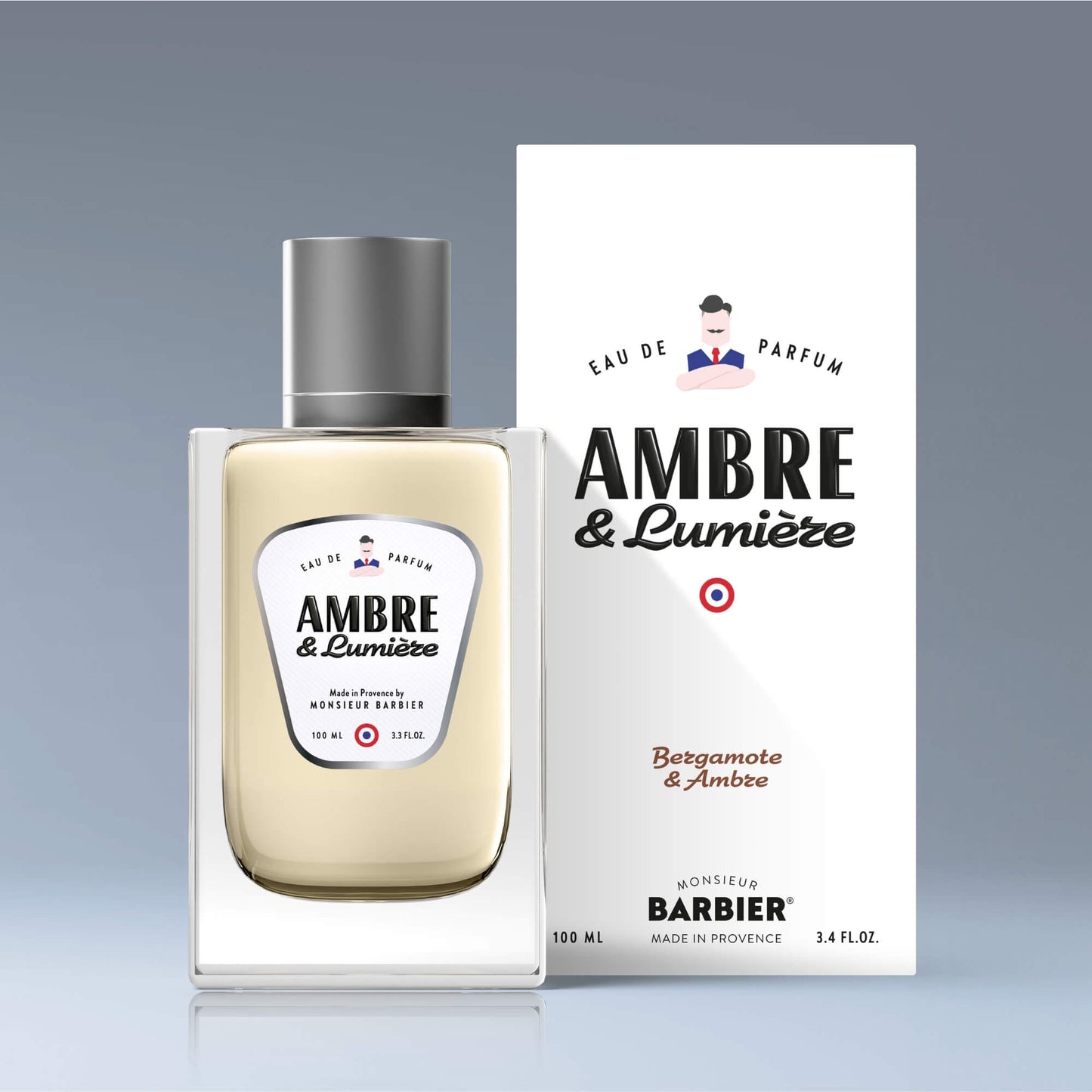 Flacon du parfum Monsieur BARBIER AMBRE & LUMIÈRE devant son emballage, 100 ml, senteurs bergamote et ambre, design chic et épuré.