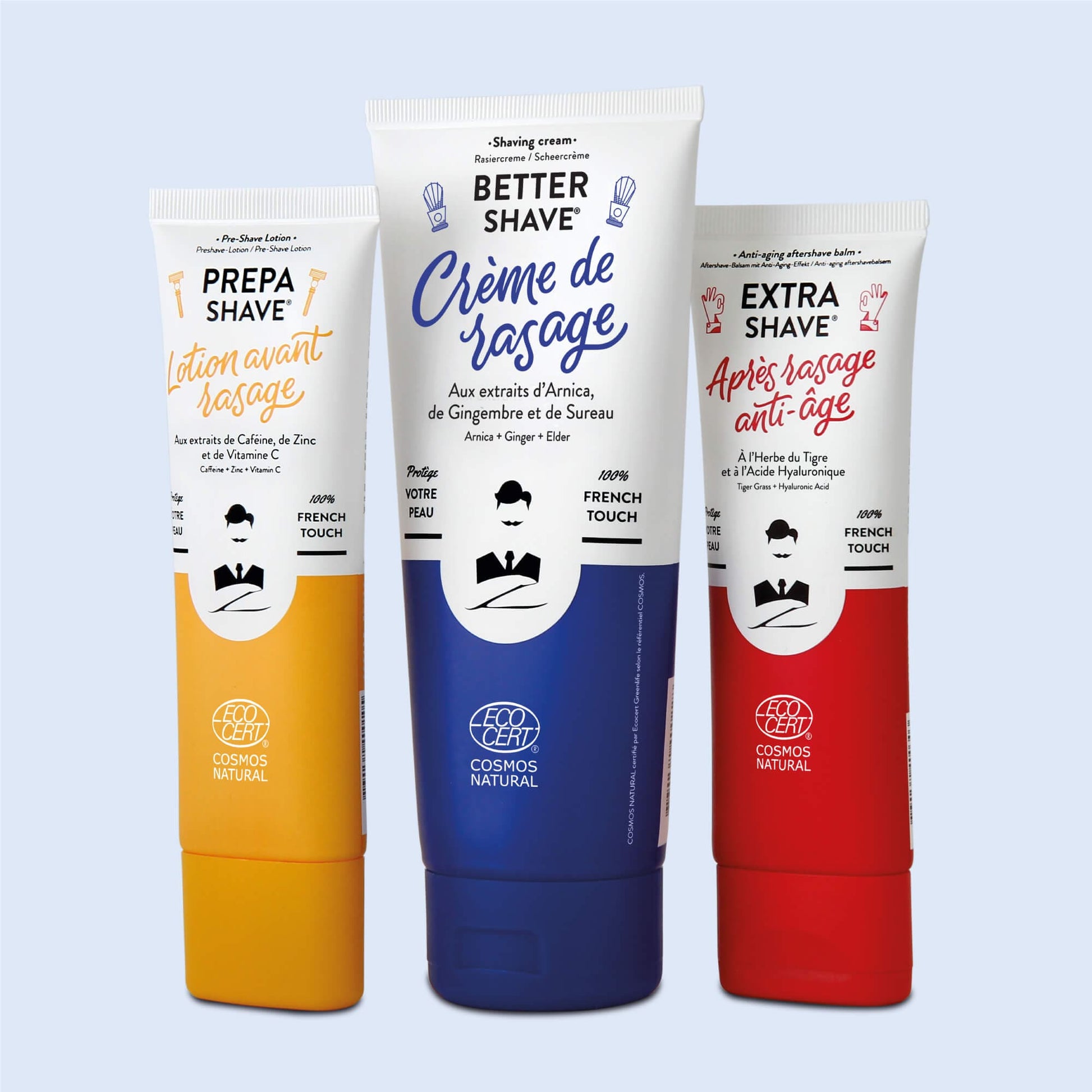 Trio de soins pour le rasage de Monsieur BARBIER dans le coffret SUPER DADDY BOX, incluant une crème de rasage, une lotion avant-rasage et un après-rasage anti-âge, avec emballages colorés en jaune, bleu et rouge.